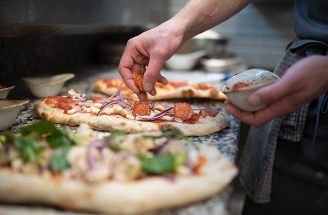 someone making a pizza