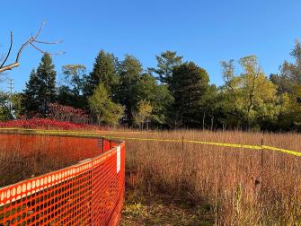 Protective fencing to keep the prairie grass safe while work is being done nearby