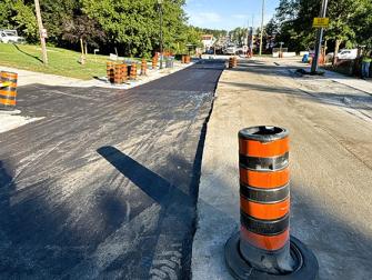 Paving a storm pipe trench with temporary asphalt