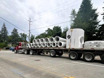 Large diameter storm pipe and structures being delivered to the site.