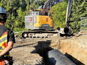 Installing a storm sewer pipe on Airport Road.