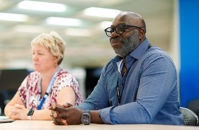 two region of peel employees working at a table